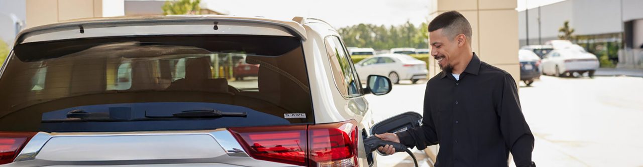 Enterprise Mobility employee recharging an electric vehicle