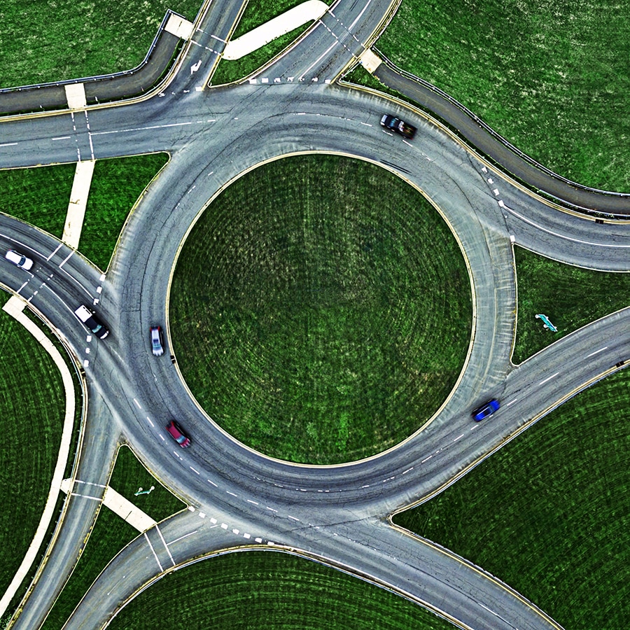 An aerial shot of an interstate with lots of green space around it.